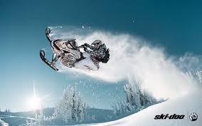 Summit snowmobile jumping in the air